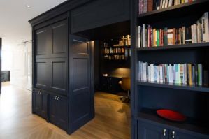 High end home office built in cabinets with library shelves, wainscotting and crown molding; all hand crafted