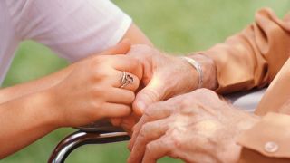 Nurse Holding Elderly Patient's Hand tsc