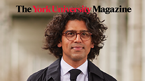 Usman Khan wears brown framed glases and a black suit with The York University Magazine text ar the top of the frame.