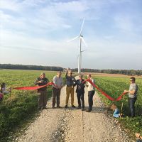 Wind turbine ribbon cutting at a community-based renewable energy project